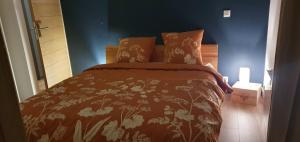 a bedroom with a bed with a blanket and pillows at Château les Poules in Assignan