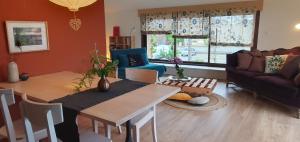 a living room with a table and a couch at Château les Poules in Assignan