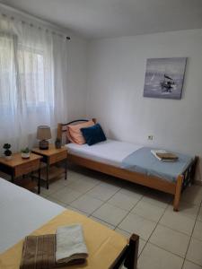 a bedroom with two beds and two tables in it at Adi's House in Kalamitsi