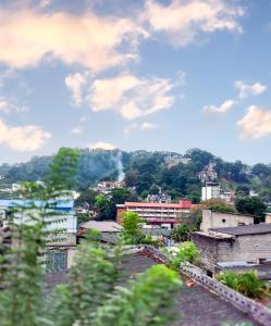 a view of a city with buildings and trees at La Belle Homestay in Kandy