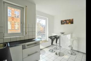 a kitchen with a counter and stools in it at Traumwohnung Stuttgart in Stuttgart