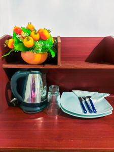 a plate and utensils on a wooden shelf at La Belle Homestay in Kandy +15 photos