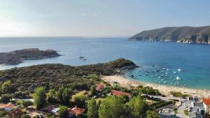 a view of a beach with boats in the water at Adi's House in Kalamitsi