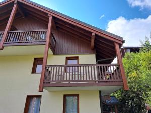 a house with a balcony on top of it at Le Corbier, T3, 4-6 pers in Villarembert