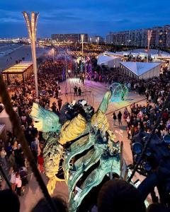 a crowd of people standing around a beach at night at La maisonnette de Camillou in Calais