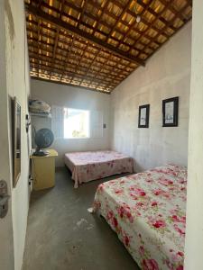 a bedroom with two beds and a window at Casa Lagoa & Praia in Estância +6 photos