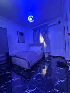 a bedroom with a bed with a blue ceiling at The Apartment at Akoka Yaba, Lagos - House 16 Shobande Street in Yaba