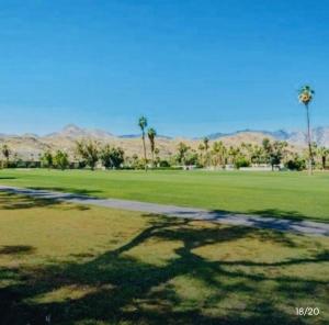 a park with a grass field and palm trees at Charming 2-Bedroom Condo in Enchanting Palm Spring in Palm Springs