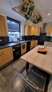 a kitchen with a wooden table and a counter top at 3 Treig Road in Fort William