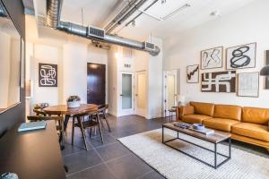 a living room with a couch and a table at DTLA 2BR Rooftop Jacuzzi & Sunset Views in Los Angeles