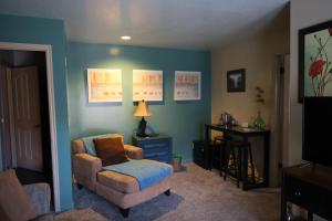 a living room with a chair and a table at Harvest House Bed and Breakfast in Springdale