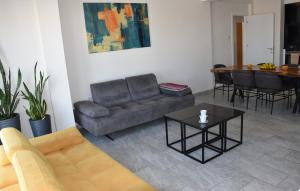 a living room with a couch and a table at Panoramic Penthouse in Mağusa +41 photos
