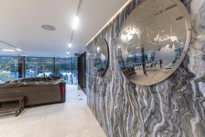 a large mirror on a wall in a room at MARION SPA Hotel in Bukovel