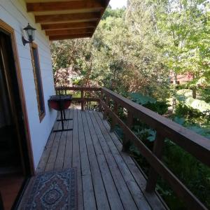 a porch of a house with a grill on it at Casa campo in Futrono