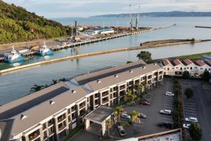 an aerial view of a building next to a marina at Pool & River Views - 600m to CBD in Gisborne