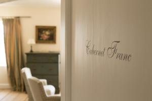 a room with chairs and a dresser and a bedroom at Château du Tertre in Arsac