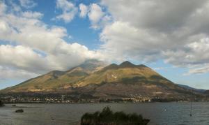 a mountain in front of a large body of water at Rincon Arrayán in Otavalo
