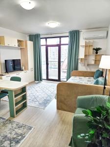 a living room with a bed and a couch at FOUR SEASONS Beach Apartment in Pomorie