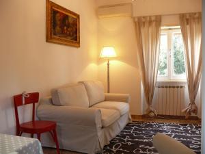a living room with a white couch and a window at Villetta Aleanto in Mentana