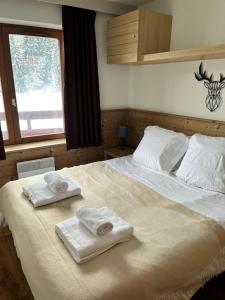 Postel nebo postele na pokoji v ubytování Courchevel au pied des pistes, La Tania