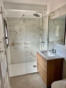 a bathroom with a sink and a shower at Villa Casa di sognu in Lecci +44 photos