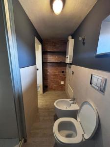 a bathroom with a toilet and a sink at Appartamento MaM Recording in Cavallermaggiore