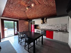 a kitchen with a black table and a red refrigerator at Appartamento MaM Recording in Cavallermaggiore