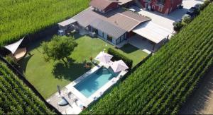 an overhead view of a house with a swimming pool at Appartamento MaM Recording in Cavallermaggiore