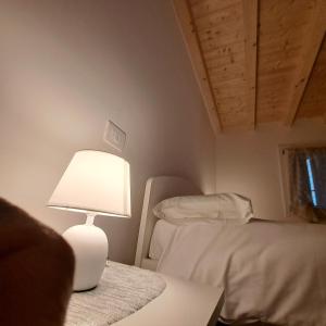 Postel nebo postele na pokoji v ubytování Sogno delle Dolomiti
