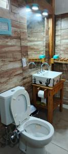 a bathroom with a toilet and a sink at La Casita del Mar in Mar del Tuyú