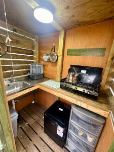 a small kitchen with a stove and a sink at The Beehive in Narberth