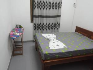 a small bedroom with a bed and a chair at Beau séjour by Mannher in Yaoundé