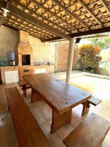 a large wooden table in the middle of a kitchen at Casa de praia na caueira com piscina in Itaporanga dʼAjuda +17 photos