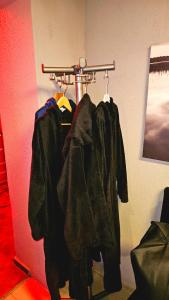 a group of jackets hanging on a rack in a room at Erwachsenen Zimmer, Spielzimmer, Playroom in Neuhausen am Rheinfall