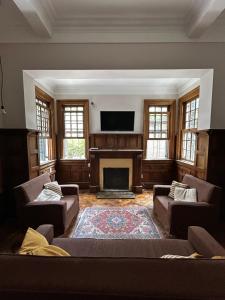 a living room with a couch and a fireplace at Hostel Plaza in Mendoza +26 photos