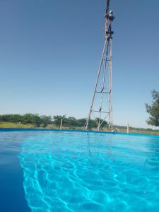 a pumping tower in the middle of a body of water at Chacra CHANCAY in Mercedes
