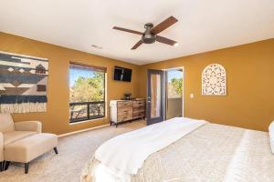 a bedroom with a bed and a ceiling fan at Flagstaff Family Retreat in Flagstaff