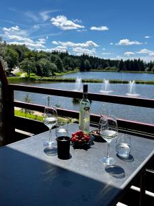 a table with wine glasses and a bottle of wine at Seeblickappartement -Eure Zeit- mit Balkon in Goslar