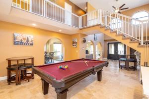 a pool table in a room with a staircase at Flagstaff Family Retreat in Flagstaff