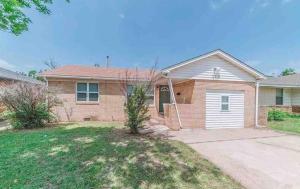 a large brick house with a driveway at Pet friendly 3 bedroom house in Oklahoma City