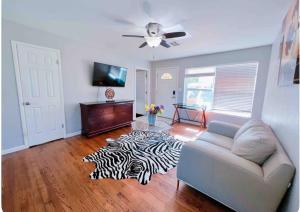 a living room with a couch and a zebra rug at Pet friendly 3 bedroom house in Oklahoma City