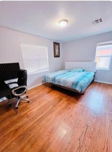 a bedroom with a bed and a desk and a chair at Pet friendly 3 bedroom house in Oklahoma City