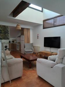 a living room with white furniture and a flat screen tv at Los Patios AT-CC-00962 in Plasencia