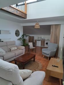 a living room with a couch and a table at Los Patios AT-CC-00962 in Plasencia