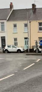 a white car parked on the side of a street at Lynne's Place in Carmarthen