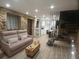 a living room with a couch and a table at Casa o Sabio in Fisterra