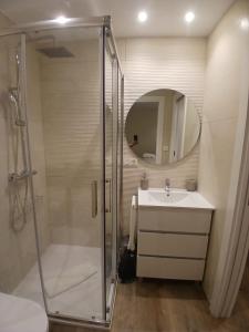 a bathroom with a shower and a sink and a mirror at Casa o Sabio in Fisterra +9 photos
