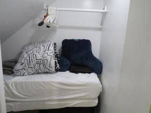 a bed with two pillows on it in a room at Coloful - Cozy - 1-BR & Sofa-bed in Waukegan