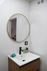 a bathroom with a sink and a mirror on the wall at Ecoloft Estudios in Cartagena +24 photos