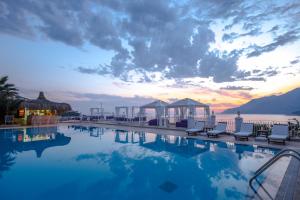 a pool with chairs and a view of the ocean at Lukka Exclusive Hotel – Adult Only +12 in Kaş